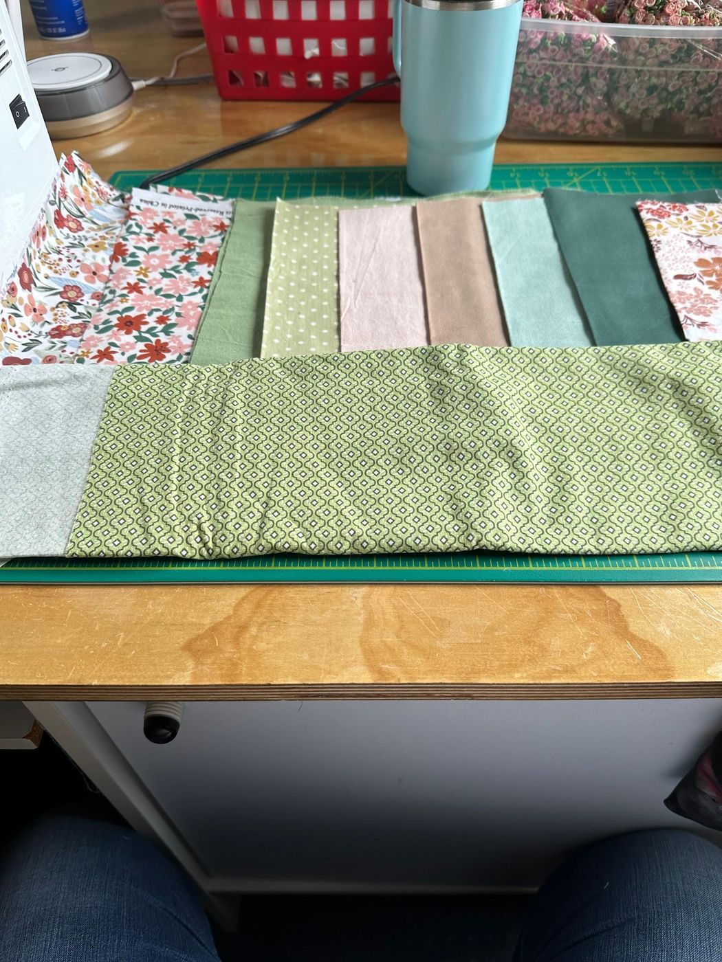 A stack of floral and gingham fabrics pulled for a quilt